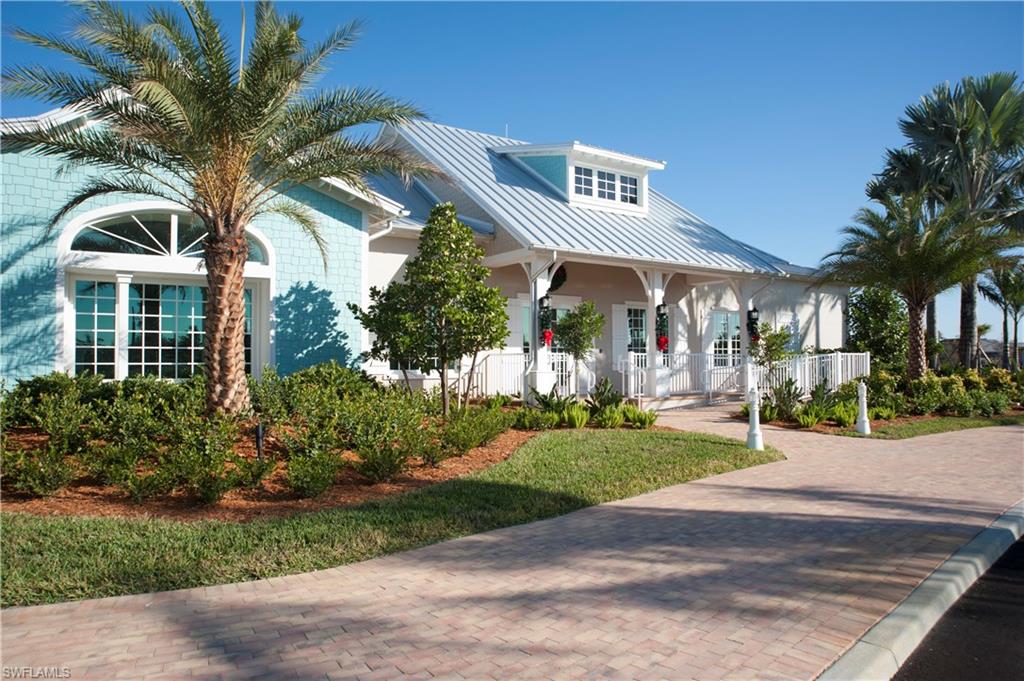 14863 Edgewater Circle Naples, FL 34114 - Photo 25 of 35 a front view of a house with a yard and potted plants
