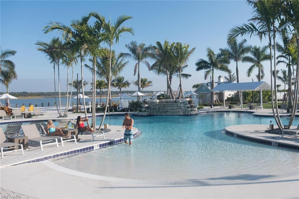 14863 Edgewater Circle Naples, FL 34114 - Photo 34 of 35 a view of a swimming pool with a table and chairs