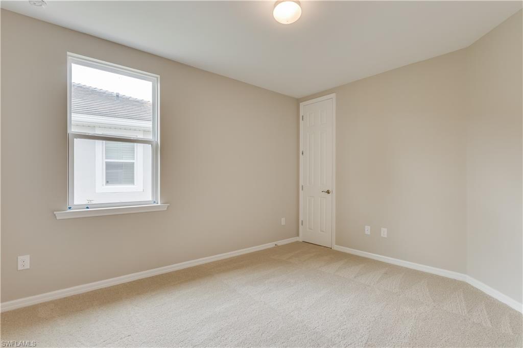 14863 Edgewater Circle Naples, FL 34114 - Photo 8 of 35 a view of an empty room with a window
