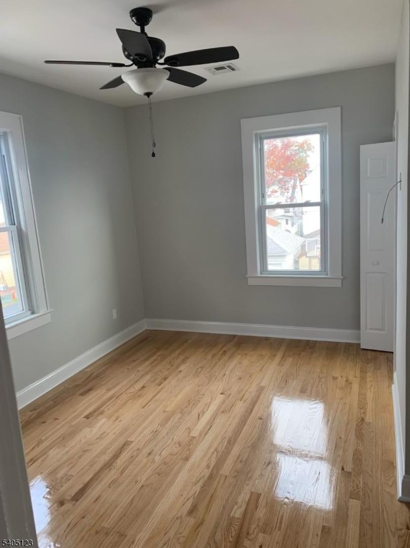 917 Madison Avenue Elizabeth, NJ 07201 - Photo 11 of 13 a view of room with window and wooden floor
