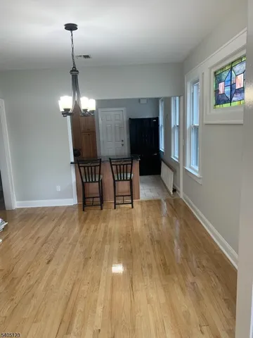 a view of a livingroom with furniture wooden floor and chandelier