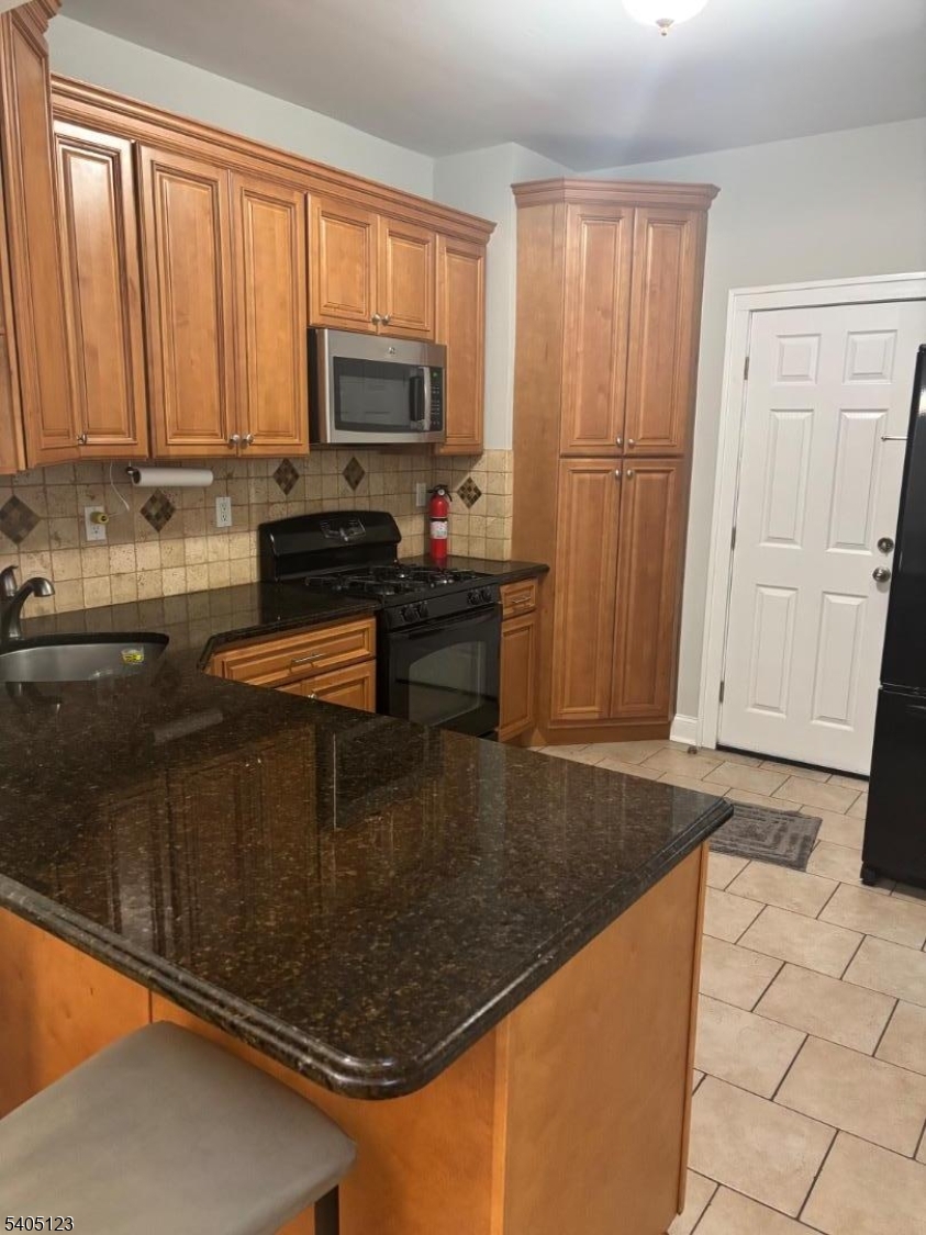 917 Madison Avenue Elizabeth, NJ 07201 - Photo 2 of 13 a kitchen with stainless steel appliances granite countertop a refrigerator sink and cabinets