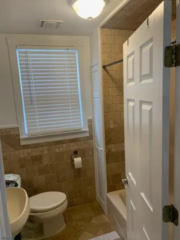 a bathroom with a toilet and shower