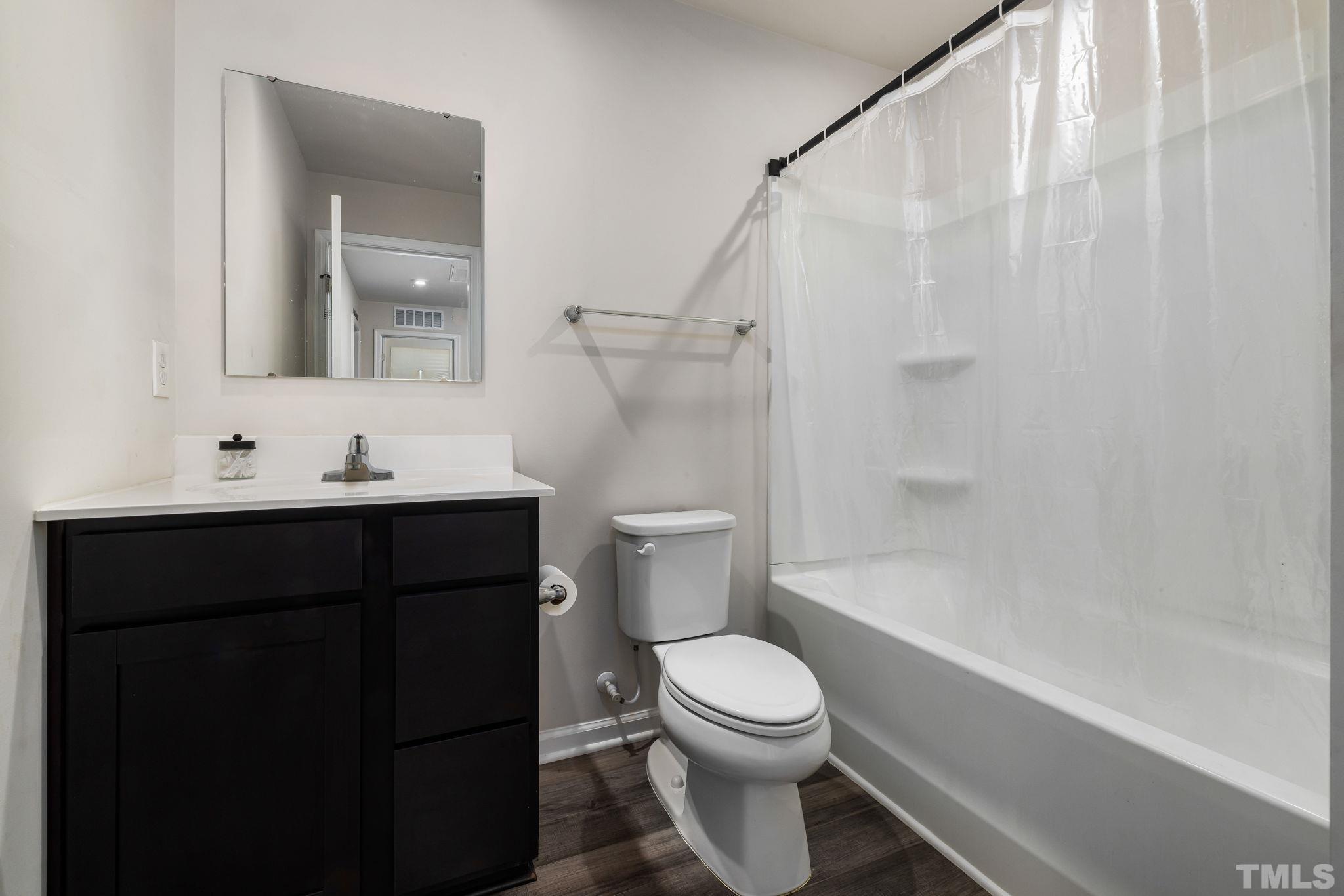 32 Powder Court Angier, NC 27501 - Photo 11 of 14 a bathroom with a sink a toilet and shower