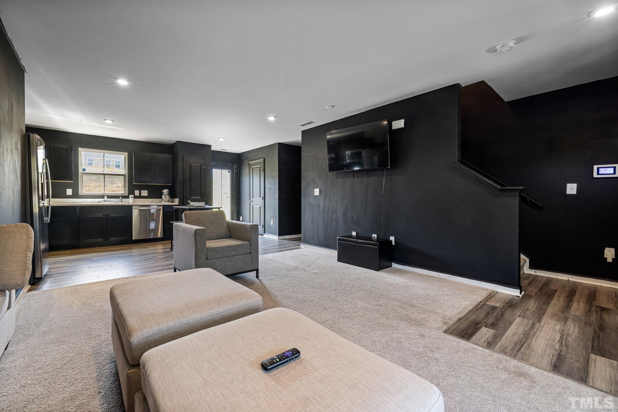 32 Powder Court Angier, NC 27501 - Photo 3 of 14 a kitchen with stainless steel appliances kitchen island granite countertop a refrigerator and a sink