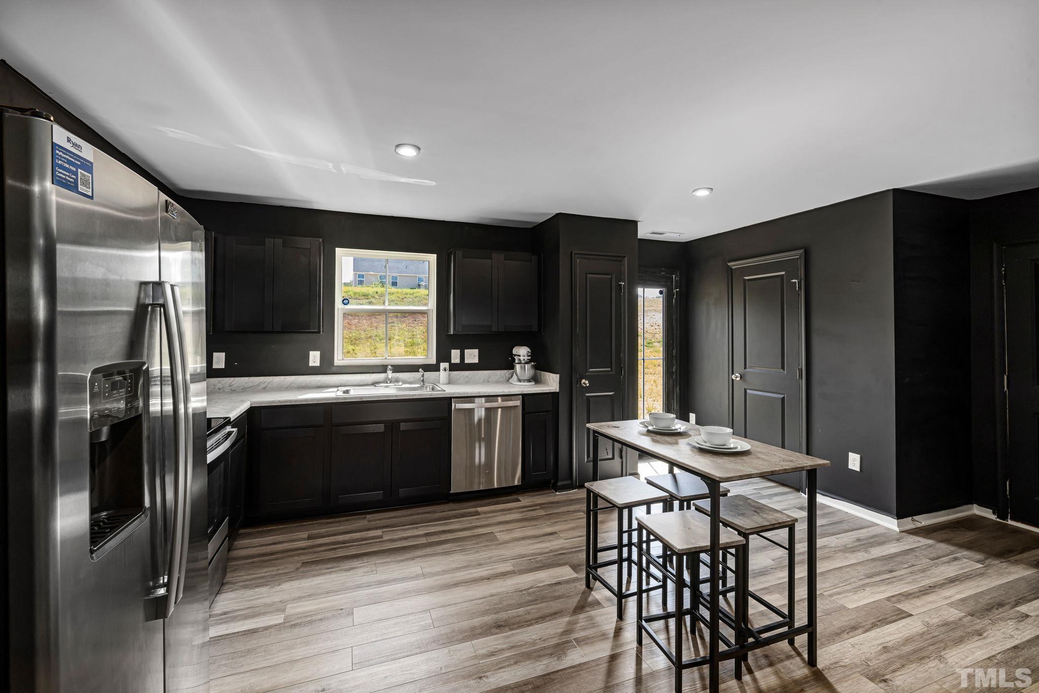 32 Powder Court Angier, NC 27501 - Photo 5 of 14 a kitchen with a refrigerator and a stove top oven
