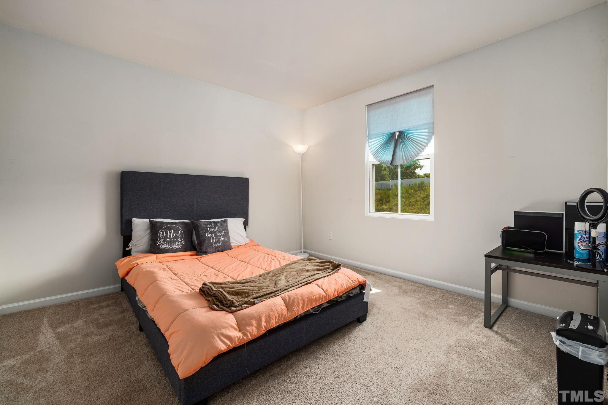 32 Powder Court Angier, NC 27501 - Photo 10 of 14 a bedroom with a bed and a window