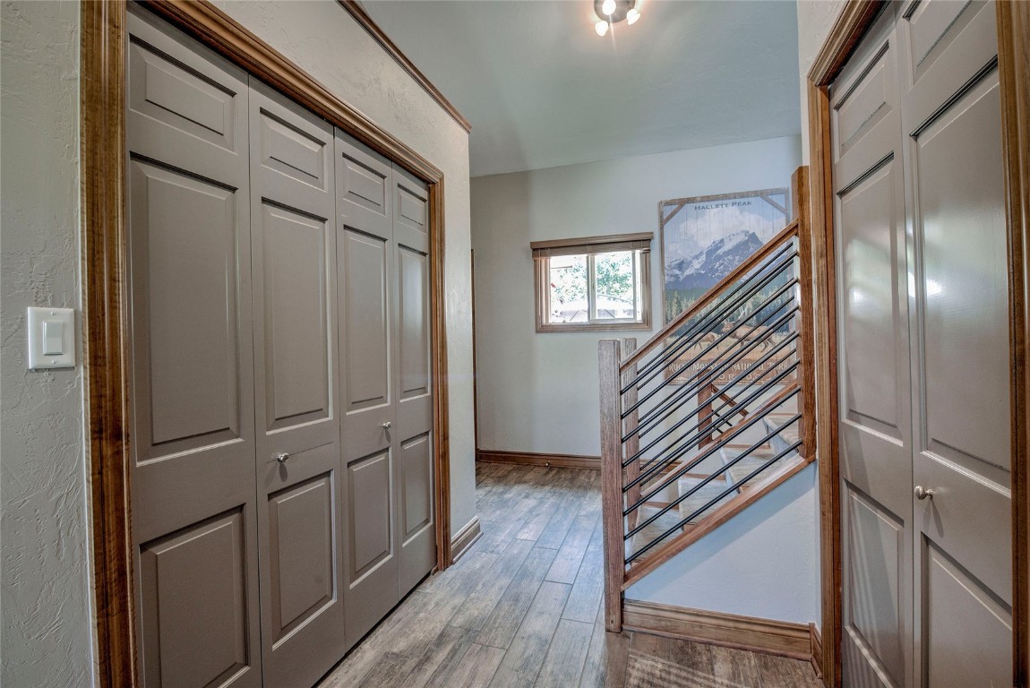 74 Big Elk Road Dillon, CO 80435 - Photo 16 of 37 a view of a hallway with wooden floor and staircase
