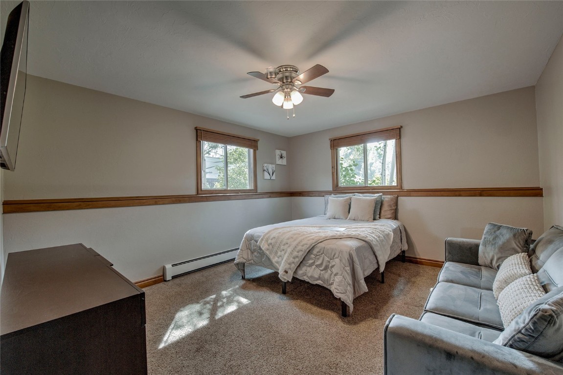 74 Big Elk Road Dillon, CO 80435 - Photo 22 of 37 a spacious bedroom with a bed and a couch