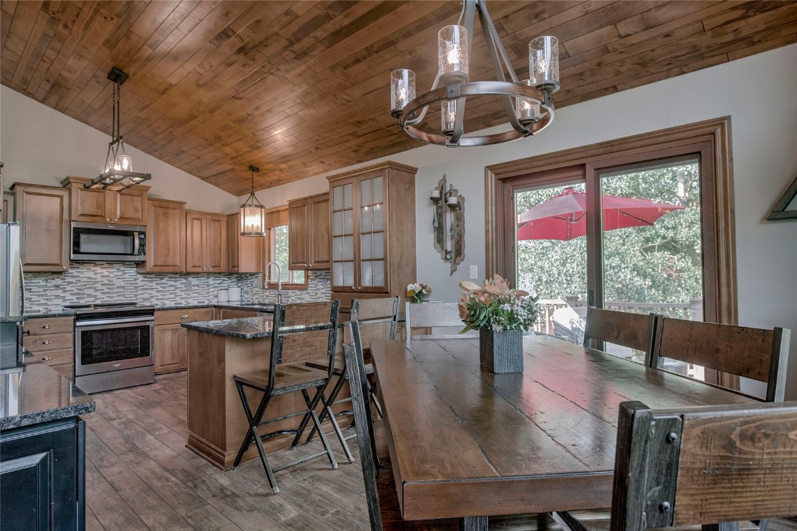 74 Big Elk Road Dillon, CO 80435 - Photo 3 of 37 a view of a dining room with furniture window and wooden floor