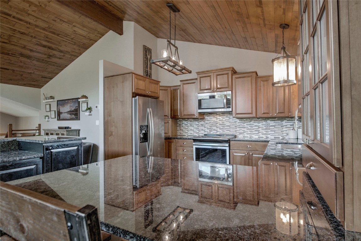 74 Big Elk Road Dillon, CO 80435 - Photo 4 of 37 a kitchen with stainless steel appliances granite countertop a sink a stove and cabinets