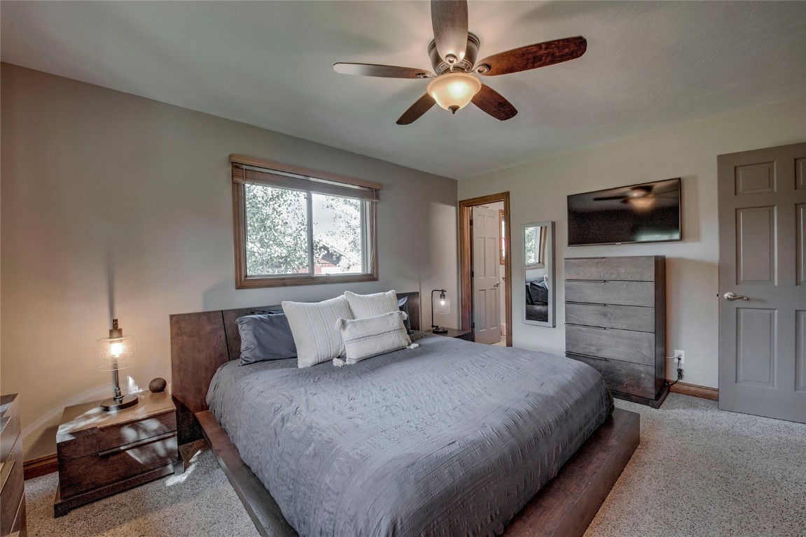 74 Big Elk Road Dillon, CO 80435 - Photo 9 of 37 a bedroom with a bed a flat tv screen and dresser