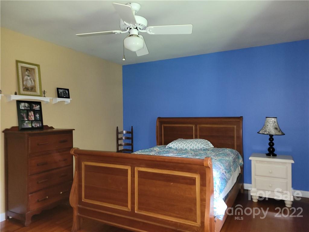 536 Biscoe Road Troy, NC 27371 - Photo 14 of 18 a bedroom with a bed and a chandelier