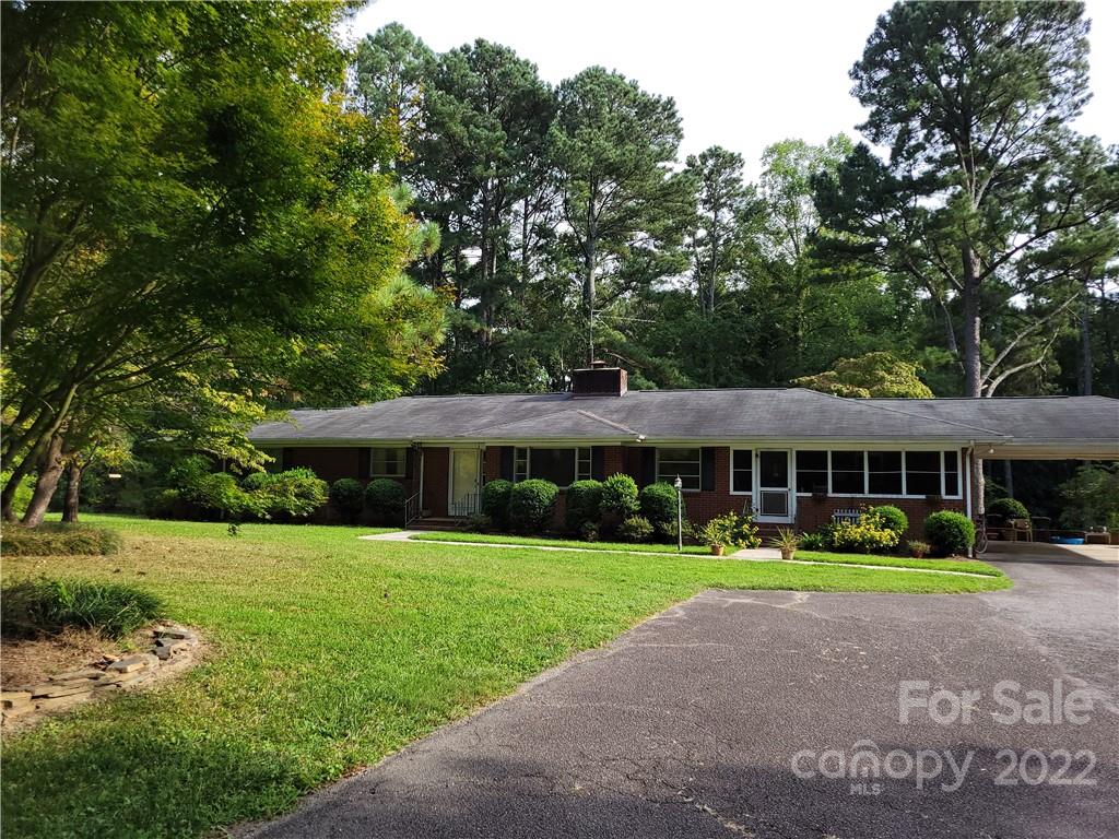 536 Biscoe Road Troy, NC 27371 - Photo 4 of 18 a front view of a house with garden and trees