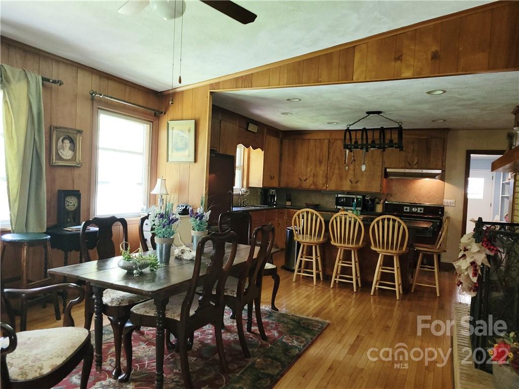 536 Biscoe Road Troy, NC 27371 - Photo 5 of 18 a dining hall with stainless steel appliances a dining table and chairs with wooden floor