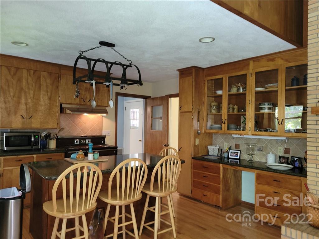 536 Biscoe Road Troy, NC 27371 - Photo 6 of 18 a kitchen with stainless steel appliances granite countertop a stove a sink and a refrigerator