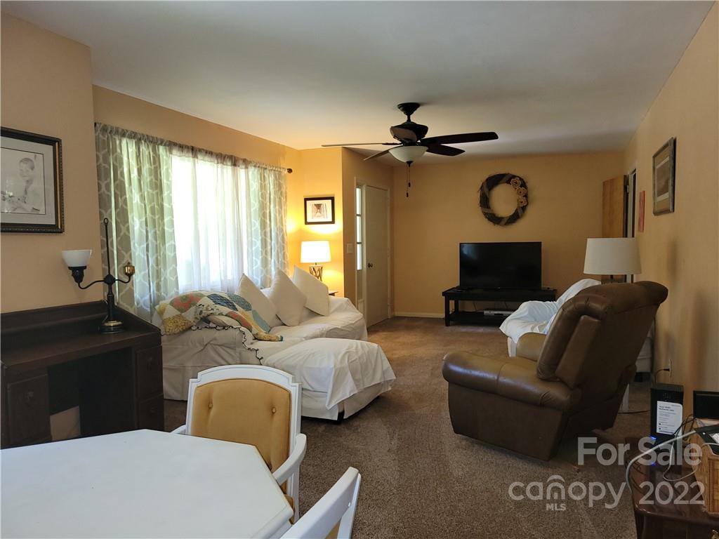 536 Biscoe Road Troy, NC 27371 - Photo 10 of 18 a living room with furniture a large window and a flat screen tv