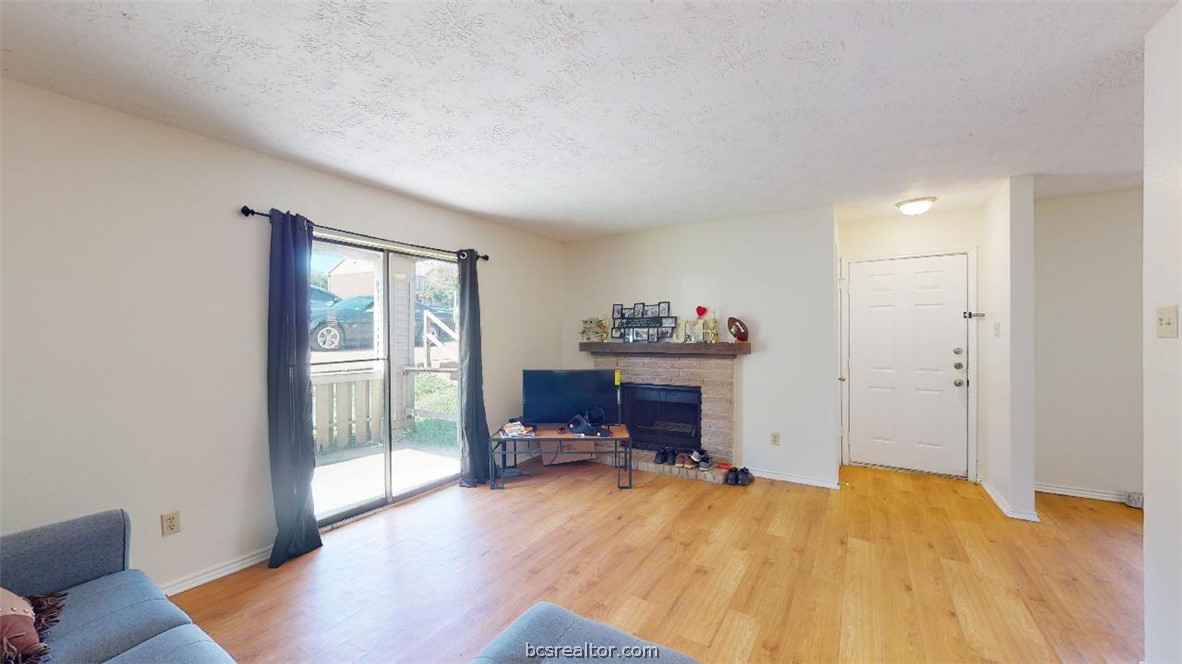 1005 Spring Loop, Unit C College Station, TX 77840 - Photo 5 of 25 a bedroom with a bed and a table