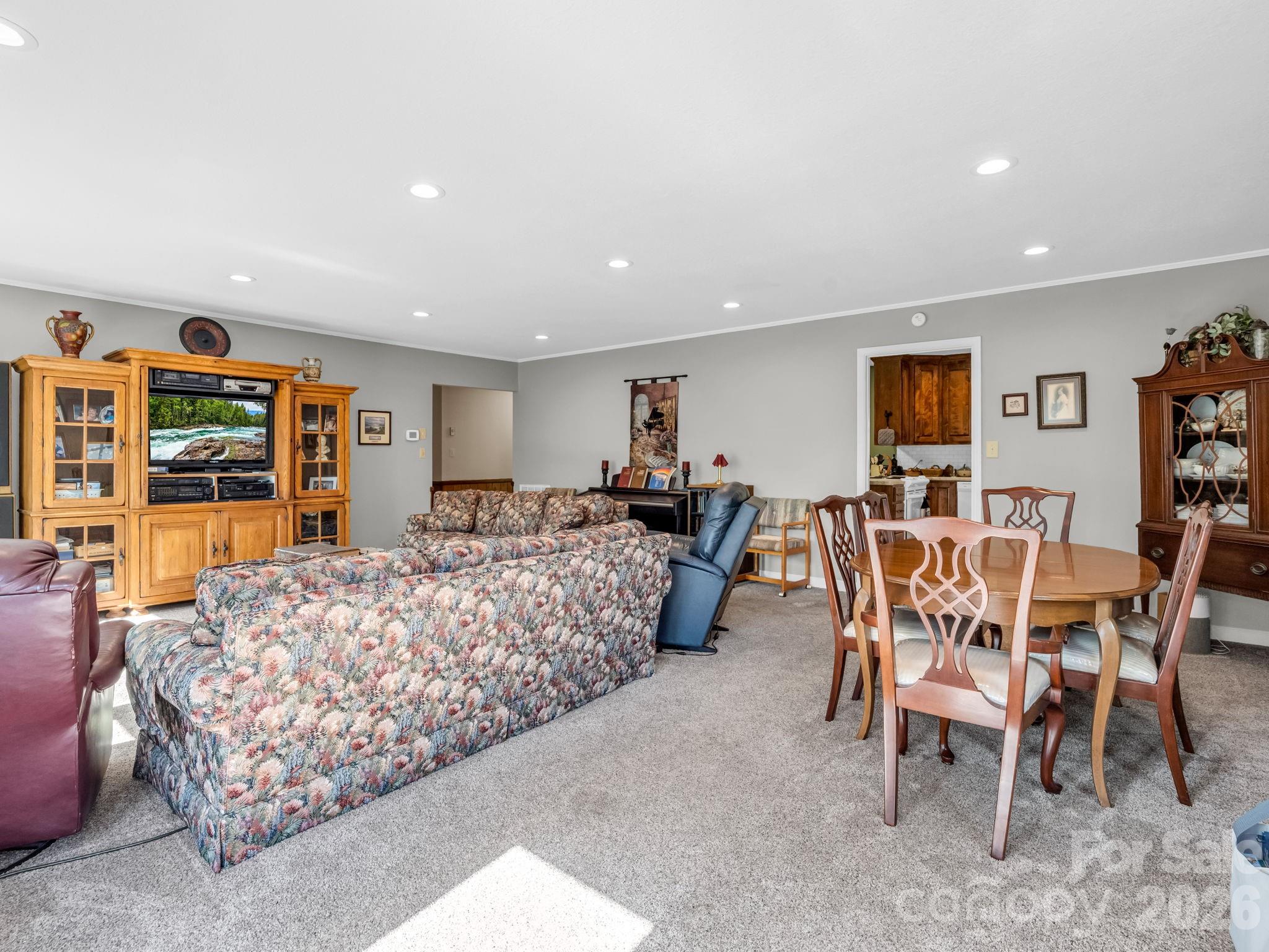 120 Warrior Drive Tryon, NC 28782 - Photo 11 of 44 a living room with furniture kitchen view and a large window