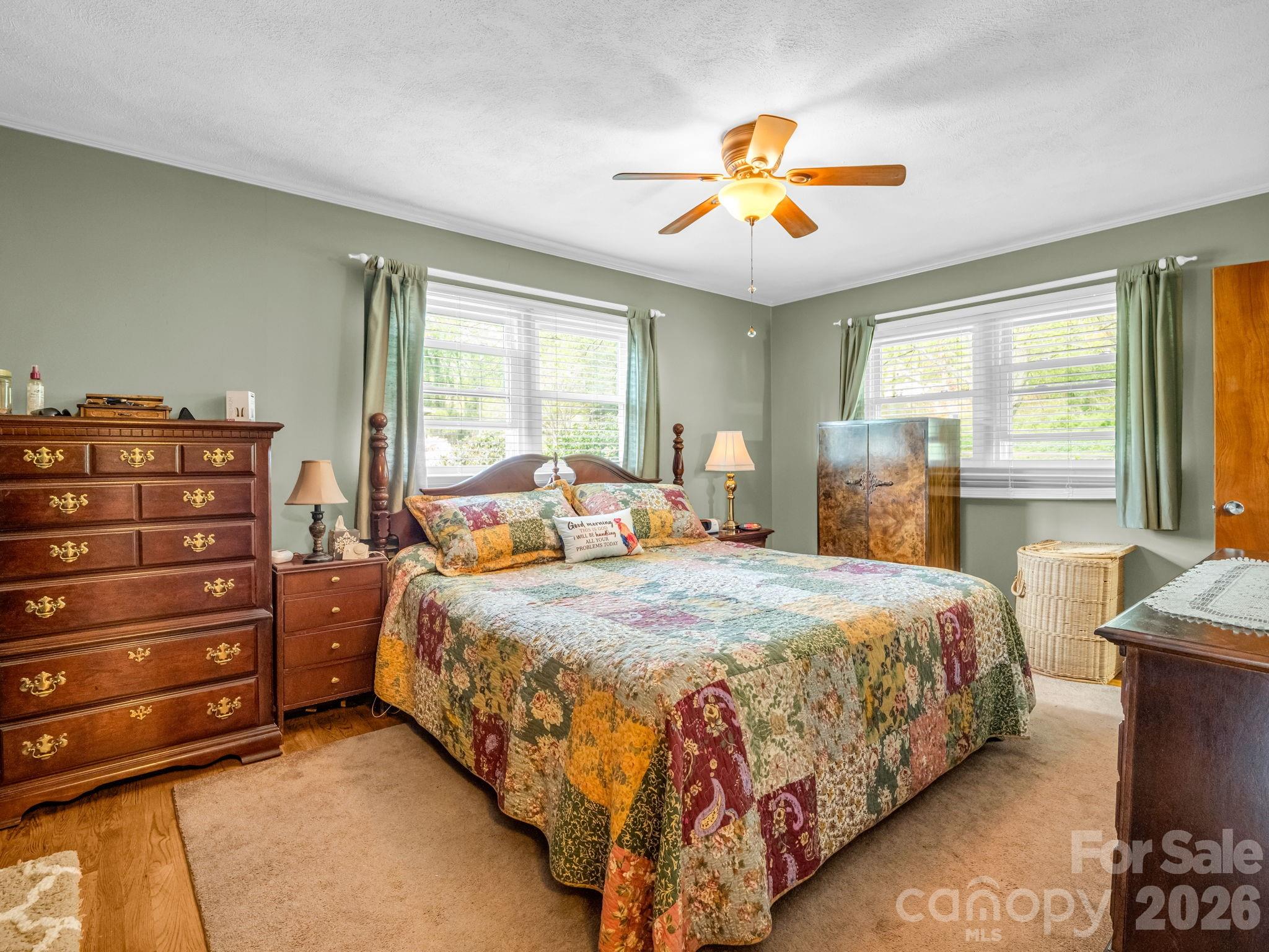 120 Warrior Drive Tryon, NC 28782 - Photo 14 of 44 a bedroom with a bed and a chandelier