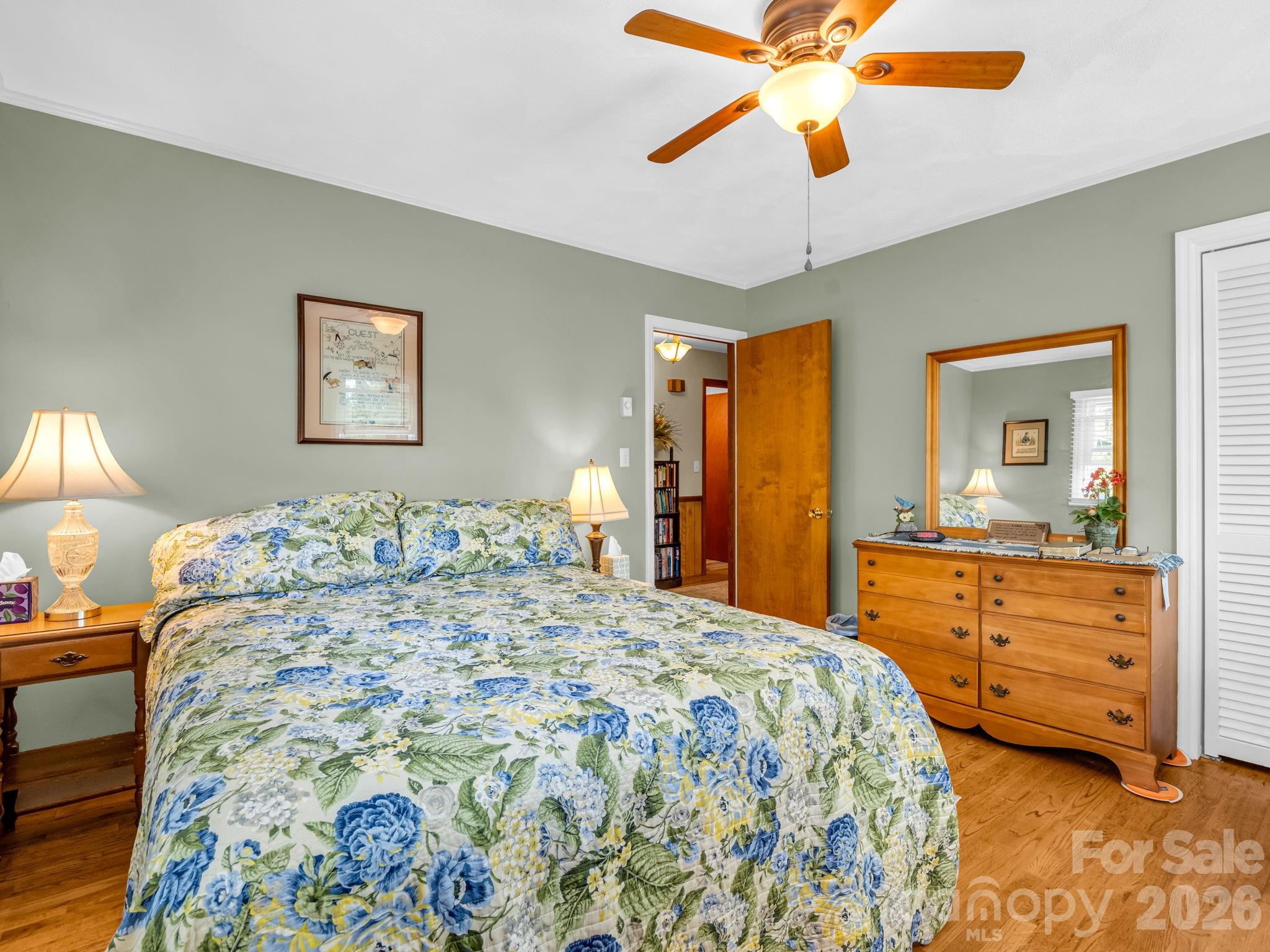 120 Warrior Drive Tryon, NC 28782 - Photo 19 of 44 a bedroom with a bed and a chandelier