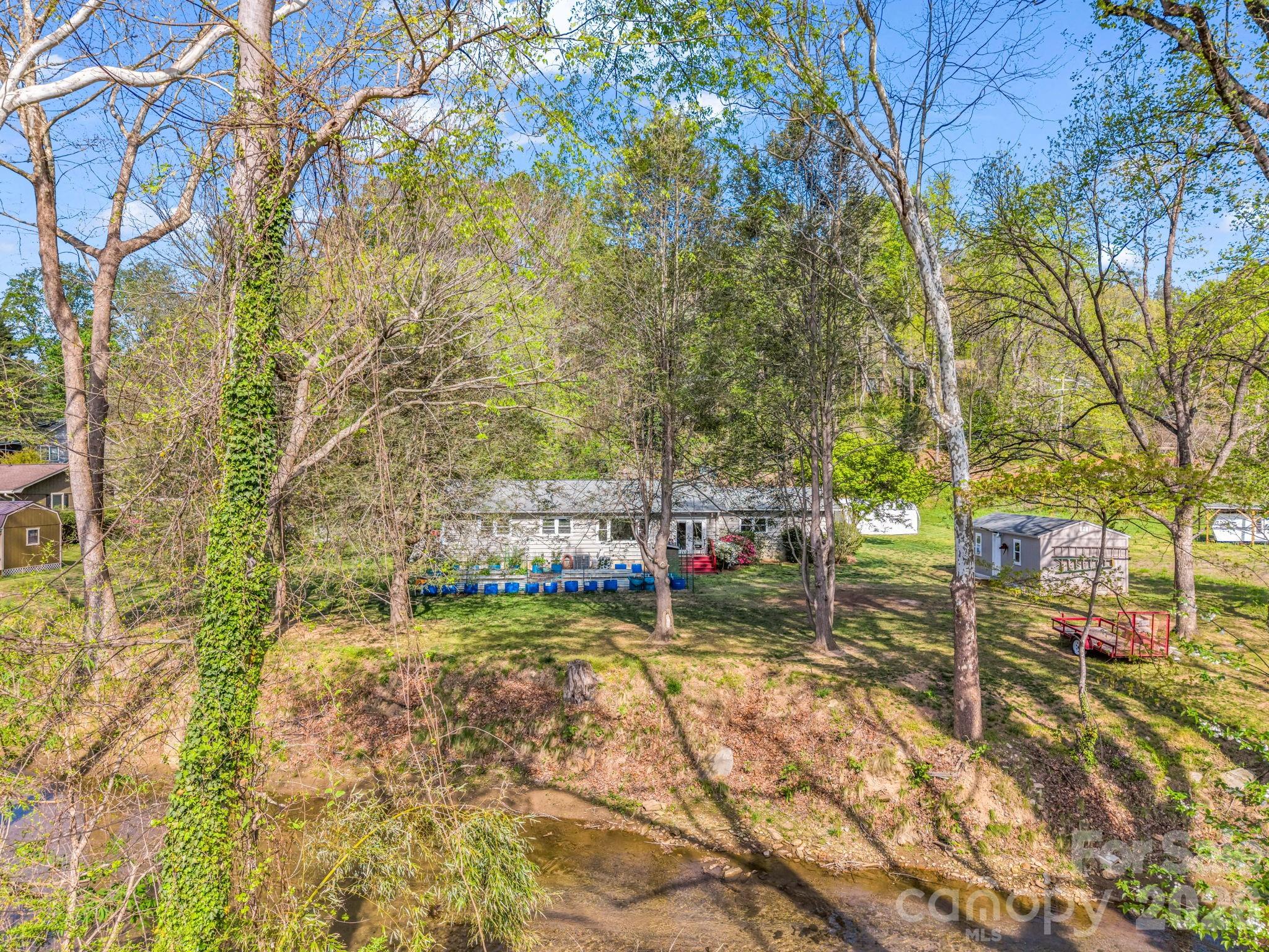 120 Warrior Drive Tryon, NC 28782 - Photo 31 of 44 a view of swimming pool with lawn chairs and wooden fence