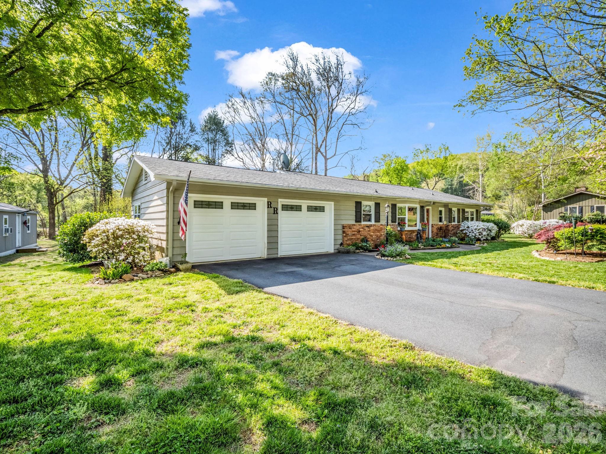 120 Warrior Drive Tryon, NC 28782 - Photo 36 of 44 a front view of a house with a yard and garage