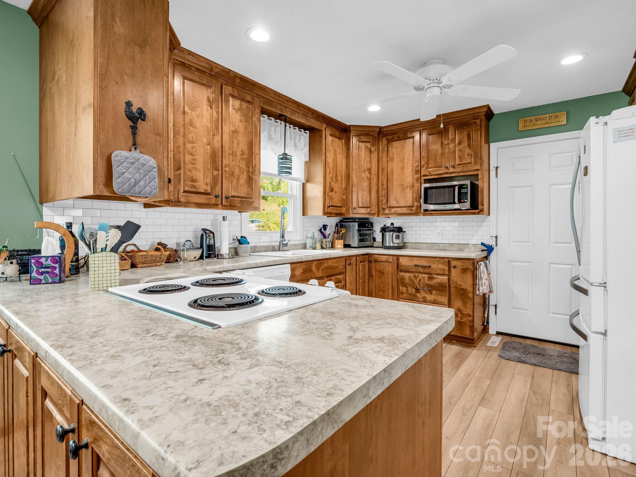 120 Warrior Drive Tryon, NC 28782 - Photo 6 of 44 a kitchen with stainless steel appliances granite countertop a sink stove and refrigerator