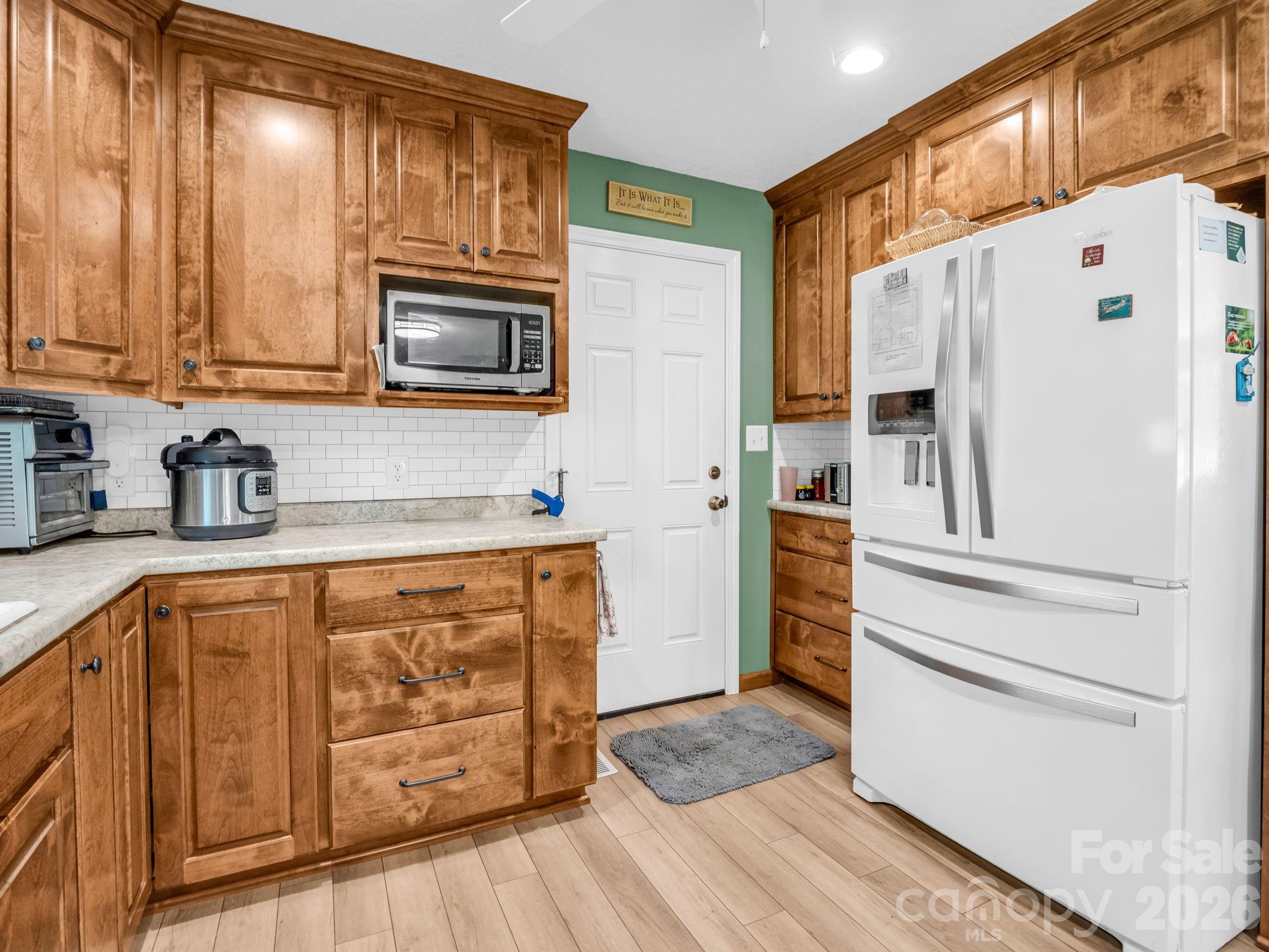 120 Warrior Drive Tryon, NC 28782 - Photo 9 of 44 a kitchen with stainless steel appliances granite countertop a refrigerator and a stove top oven