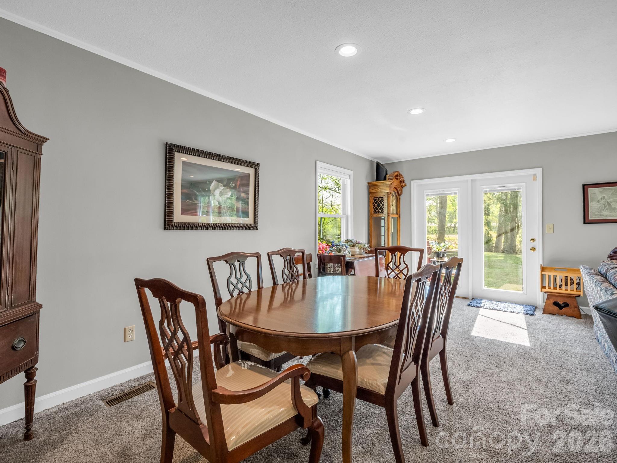 120 Warrior Drive Tryon, NC 28782 - Photo 10 of 44 a view of a dining room with furniture window and wooden floor