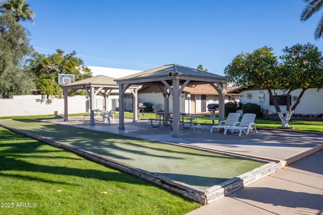 a view of a house with swimming pool and sitting area