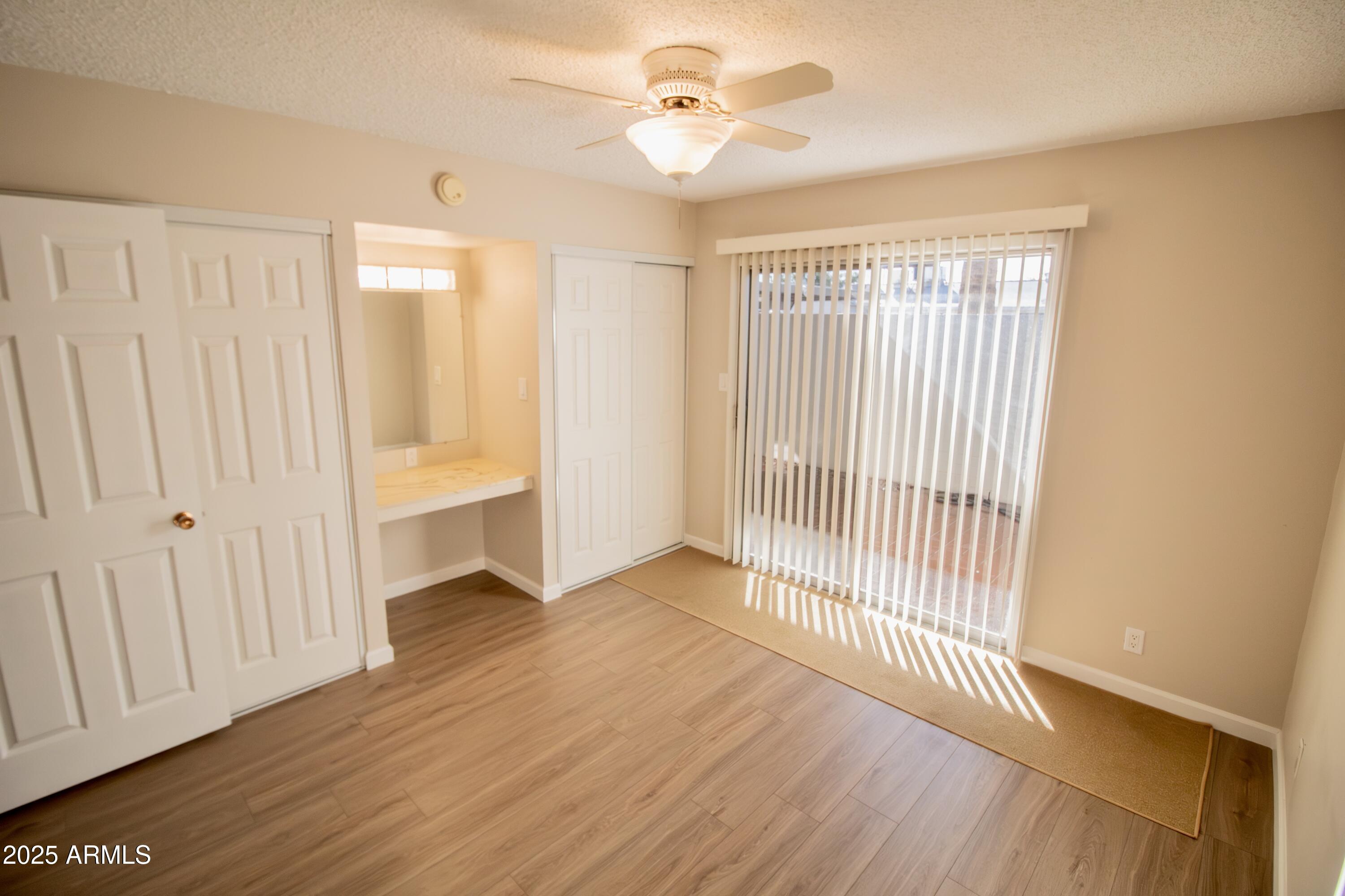 6721 East McDowell Road, Unit G304 Scottsdale, AZ 85257 - Photo 5 of 14 wooden floor in an empty room with a window
