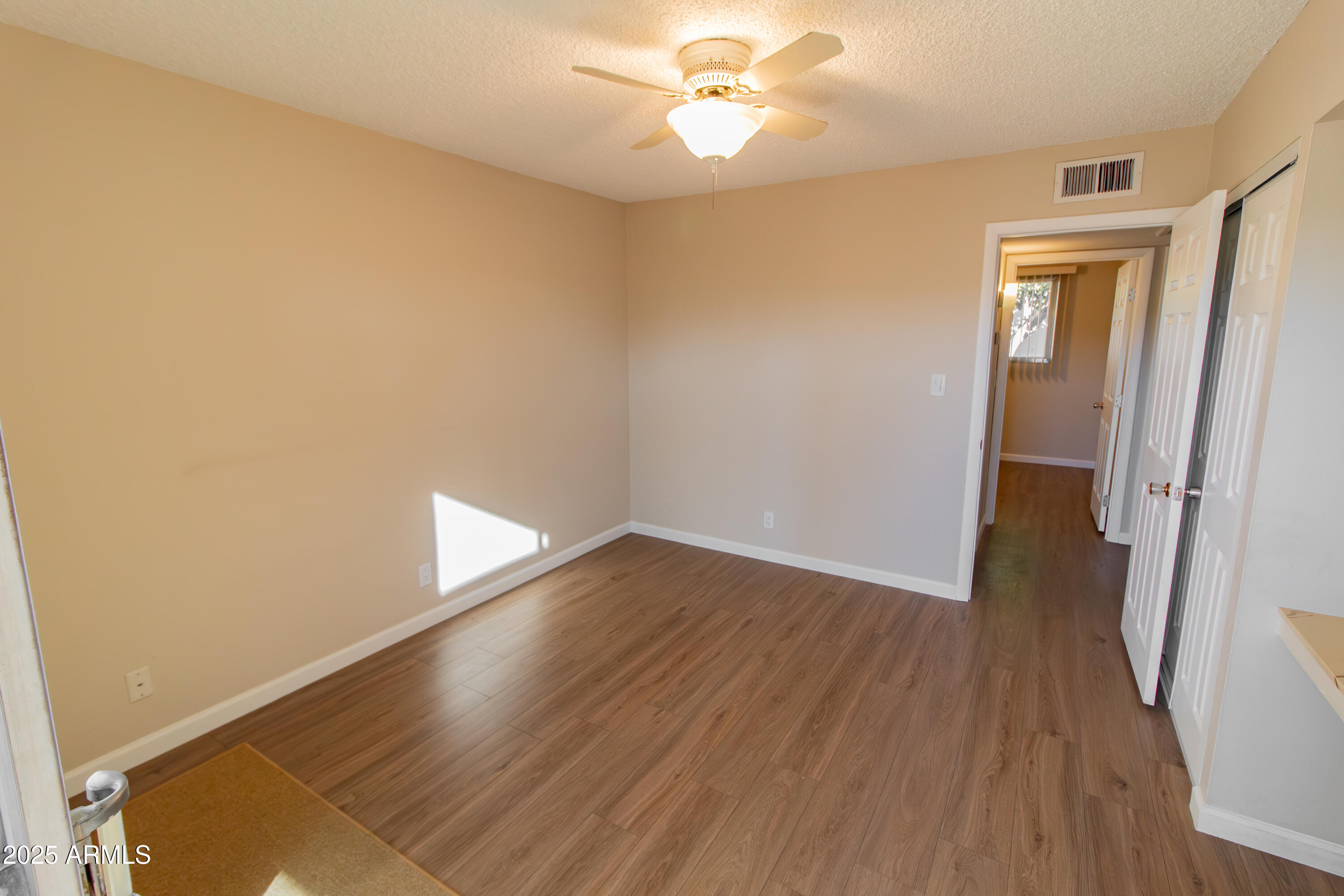 6721 East McDowell Road, Unit G304 Scottsdale, AZ 85257 - Photo 6 of 14 wooden floor in an empty room with a window