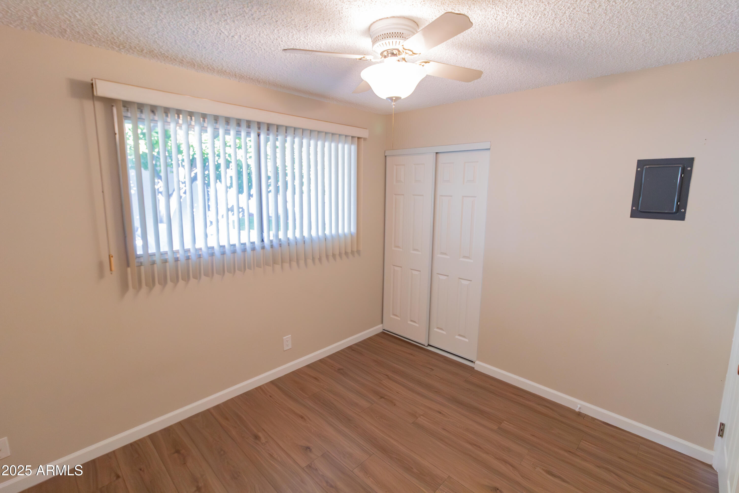 6721 East McDowell Road, Unit G304 Scottsdale, AZ 85257 - Photo 7 of 14 a view of an empty room with wooden floor and a window
