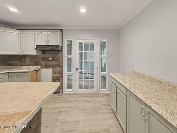 a kitchen with stainless steel appliances granite countertop a refrigerator and a sink