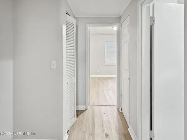 a view of an empty room and wooden floor