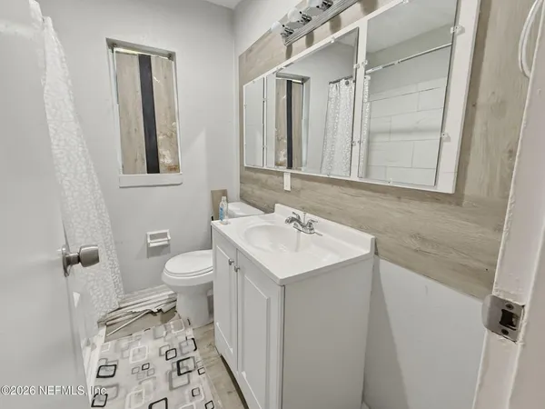 a bathroom with a sink toilet and shower