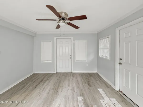 a view of empty room with wooden floor