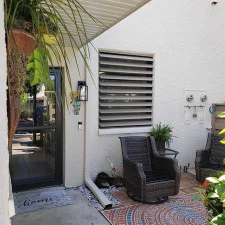 a view of backyard with outdoor seating and plants