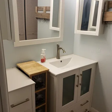 a utility room with a sink and a mirror