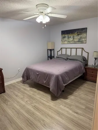 a bedroom with a large bed and a chandelier