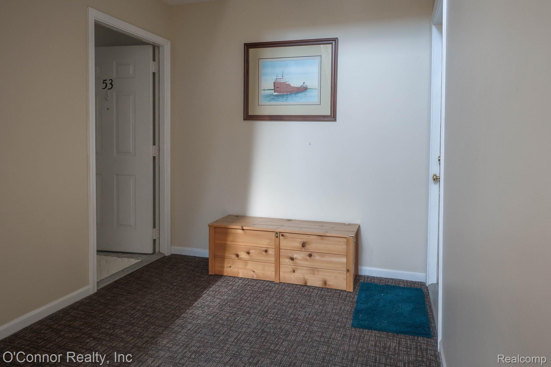 1660 River Road, Unit 53 Marysville, MI 48040 - Photo 26 of 31 Hallway with dark carpet and baseboards