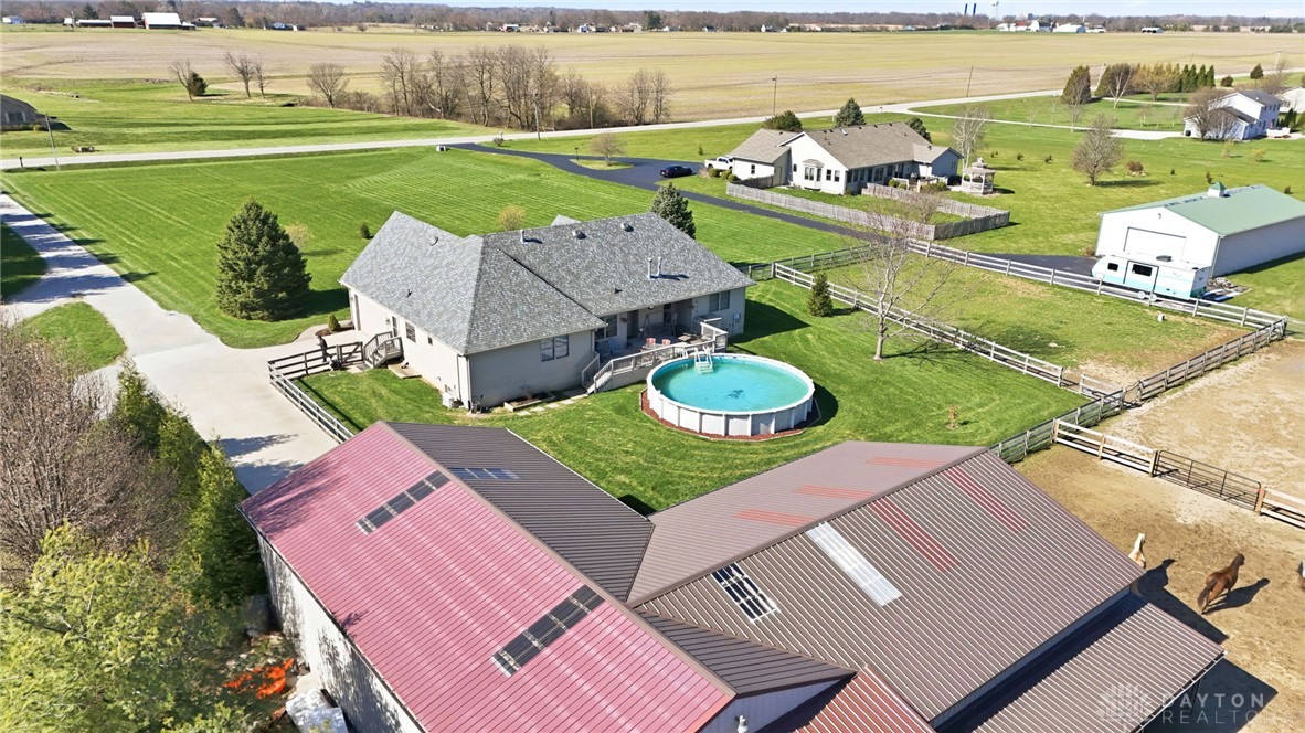 1540 Jasper Road Xenia, OH 45385 - Photo 4 of 91 This aerial view showcases a residential property with an inviting pool, set against a backdrop of open fields.