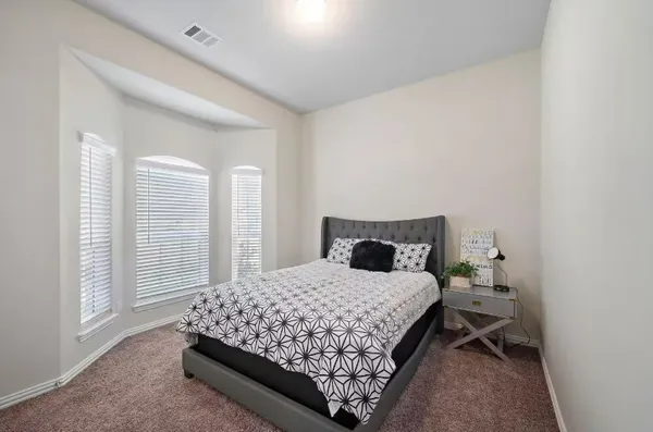 a bedroom with a bed and window