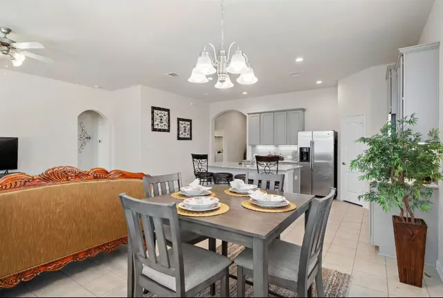 a view of a dining room with furniture and chandelier