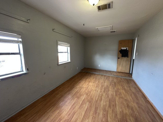 548 Spring River Drive Martindale, TX 78655 - Photo 16 of 17 Unfurnished room featuring wood finished floors and attic access