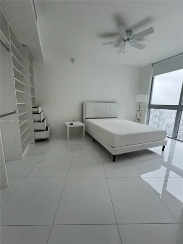 a bedroom with a bed and the view of bathroom