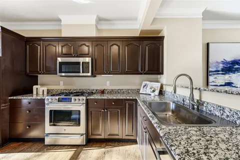 a kitchen with sink a microwave and stove