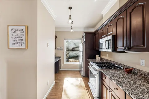 a kitchen with stainless steel appliances granite countertop a stove and a refrigerator