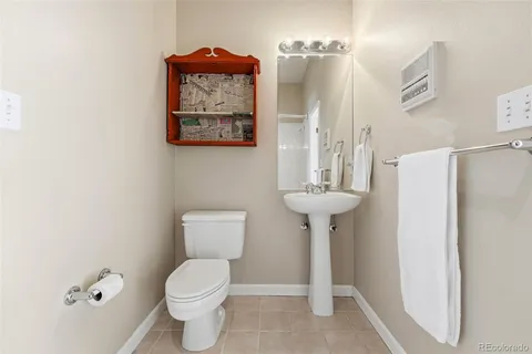 a bathroom with a toilet sink and a mirror